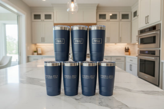 Set of blue tumblers with silver lids on a white background