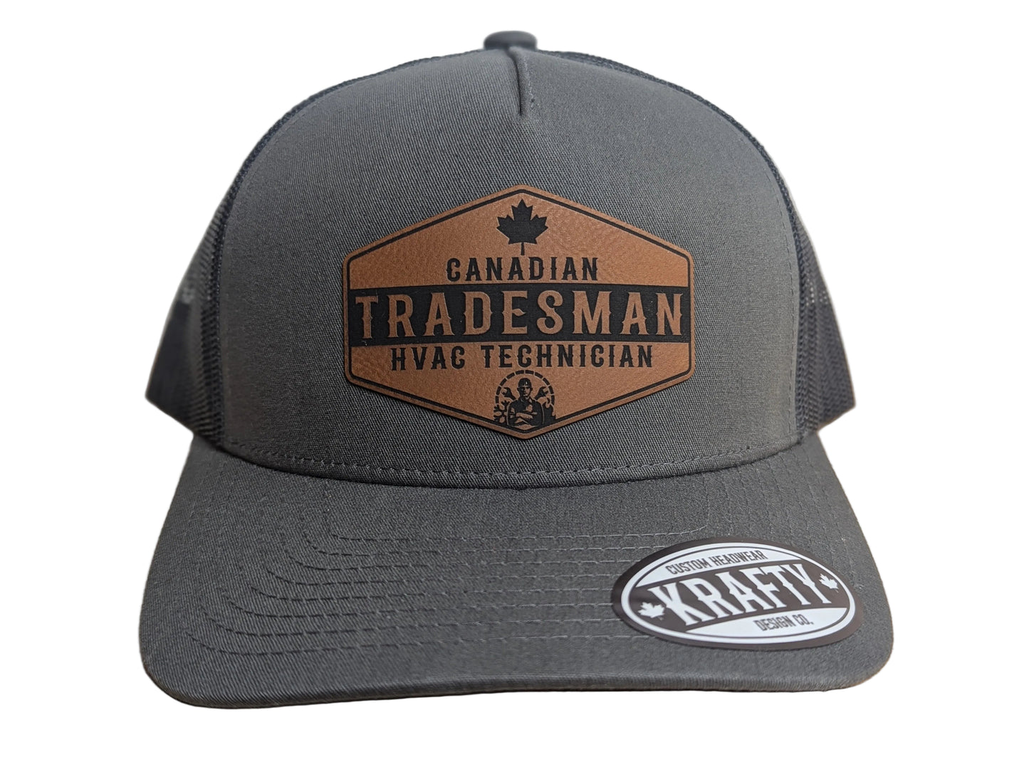 Gray cap with 'Canadian Tradesman HVAC Technician' logo on a wooden surface