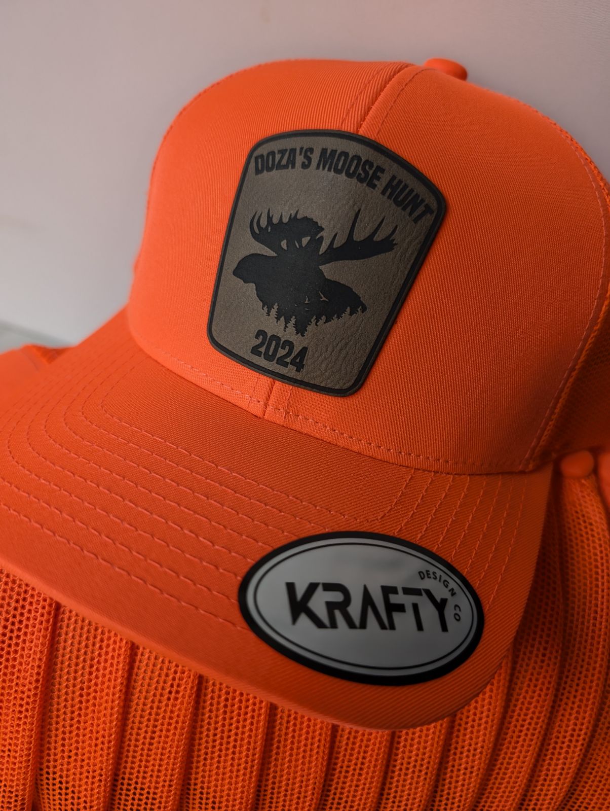 Blaze orange trucker hat featuring moose hunting patch