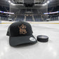a black trucker hat featuring a rawhide patch featuring a hockey goalie and custom name MATT across the design