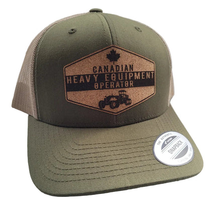 A green and beige trucker hat with a patch that reads 'Canadian Heavy Equipment Operator' and an emblem of a maple leaf and a gear.