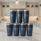 Set of blue tumblers with silver lids on a white background