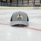 A gray trucker hat with a patch on the front that reads 'Weekend Forecast 100% chance of Hockey' and a logo on the brim.