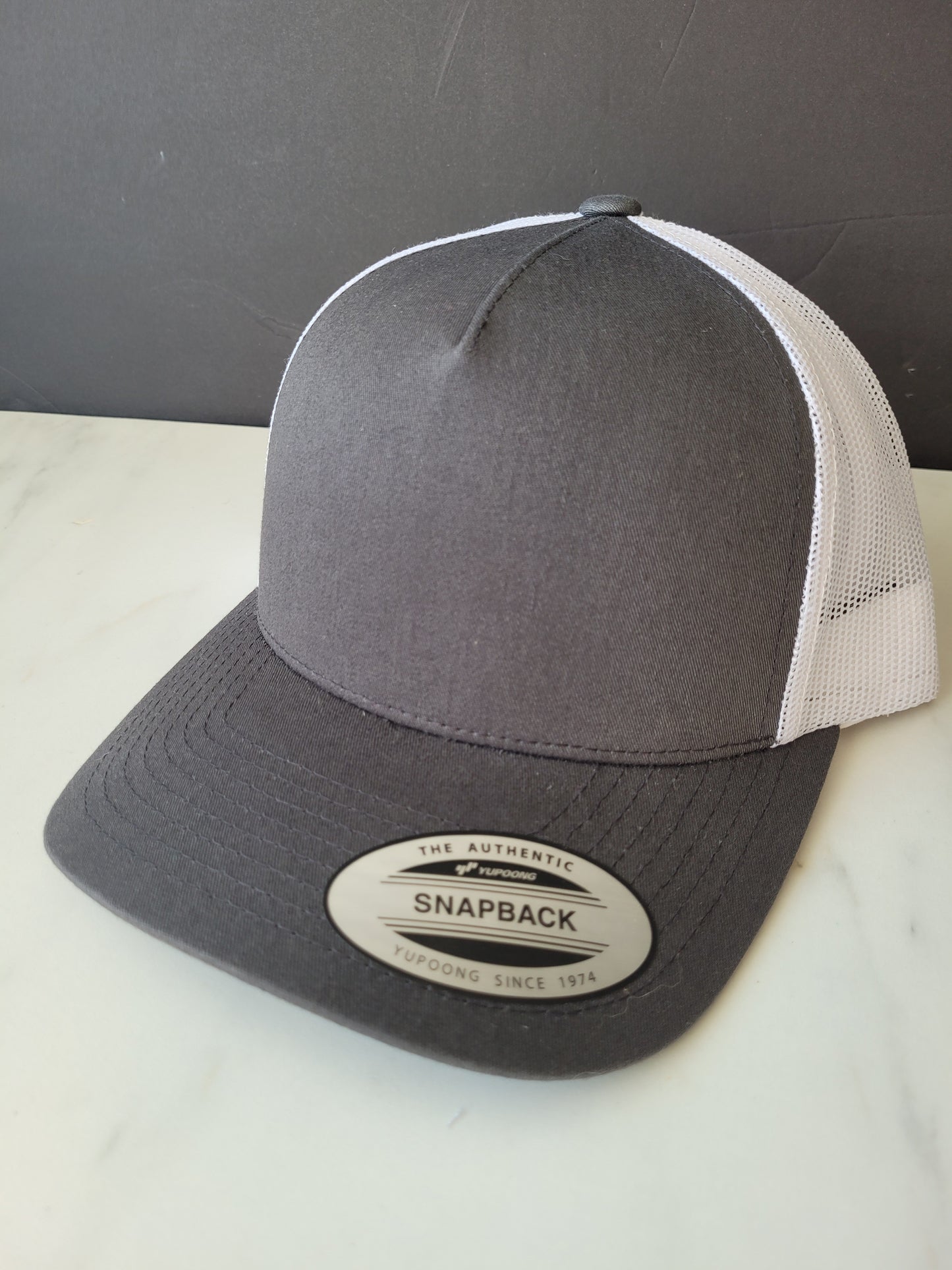 Dark grey/white snapback hat